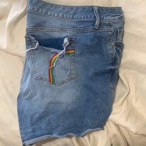 blue jean ripped shorts with rainbow on back pocket